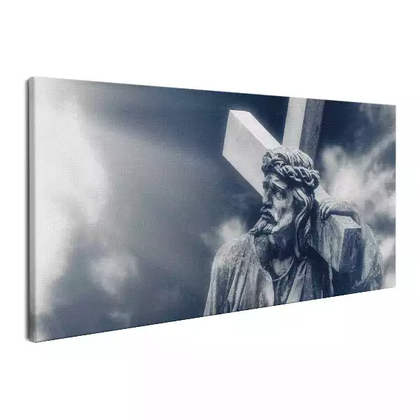 Obraz na płótnie Kamienna rzeźba Jezusa z krzyżem i niebo