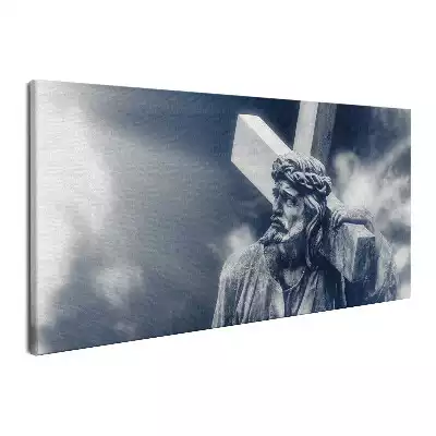 Obraz na płótnie Kamienna rzeźba Jezusa z krzyżem i niebo