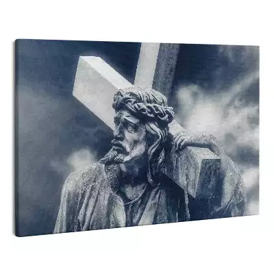 Zdjęcie na płótnie Kamienna rzeźba Jezusa z krzyżem i niebo